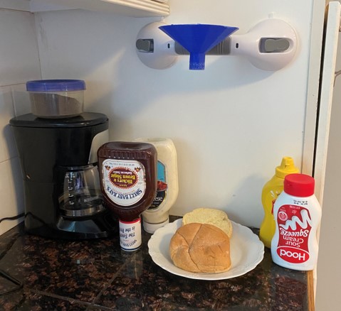 the funnel and pump being used to dispense condiments