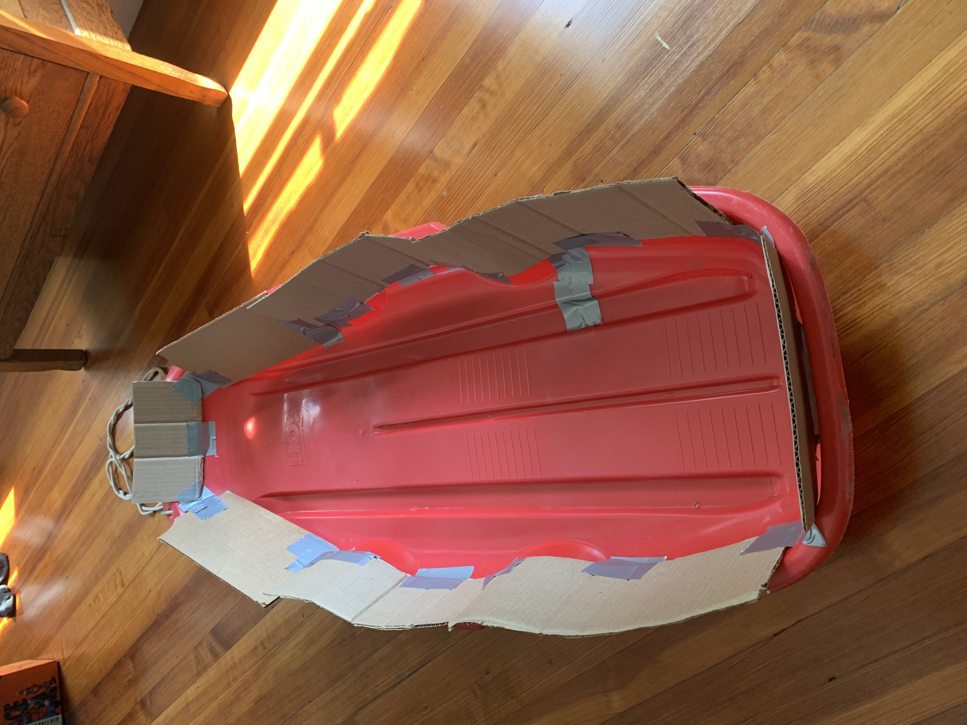 a sled with cardboard on the edges